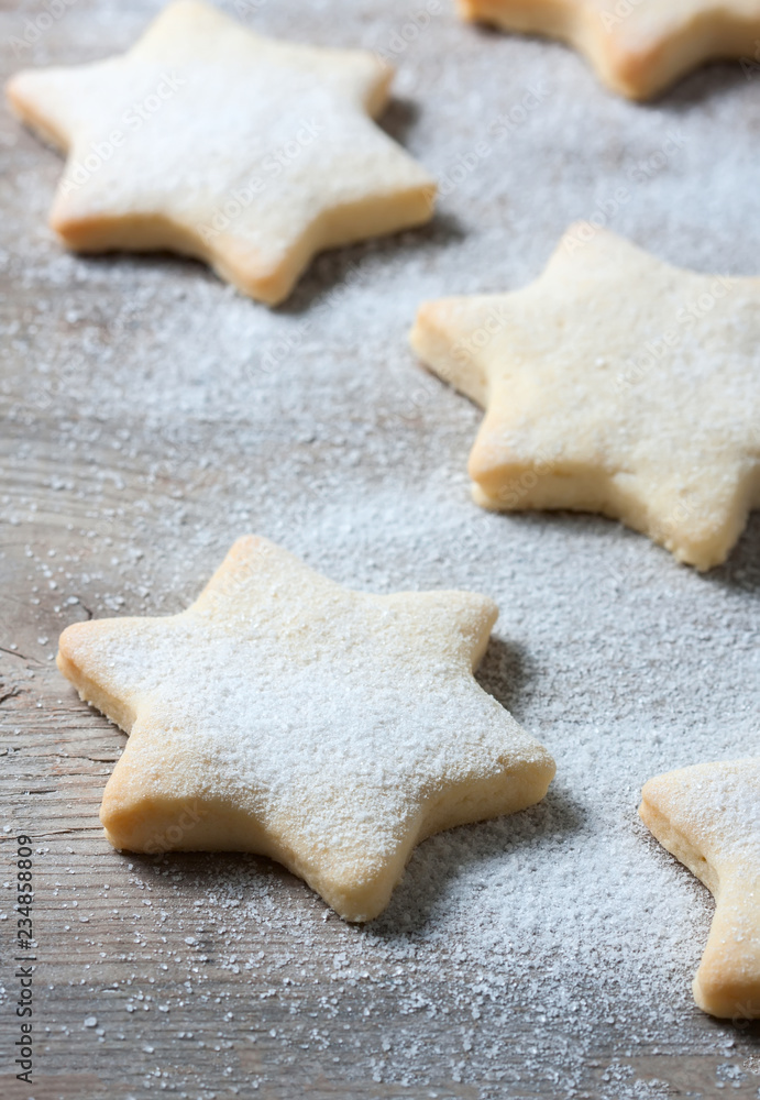 Homemade star shaped cookies on a wooden background. Christmas decoration