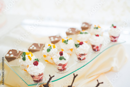 Delicious sweets on wedding candy buffet with desserts  cupcakes