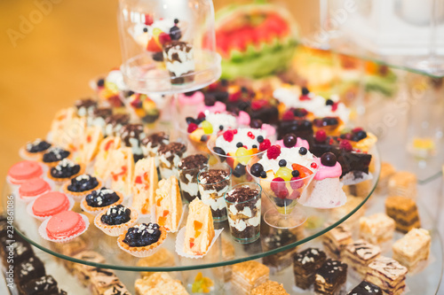 Delicious sweets on wedding candy buffet with desserts, cupcakes © olegparylyak
