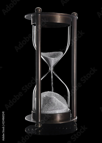 Bronze sandglass with white sand isolated on black
