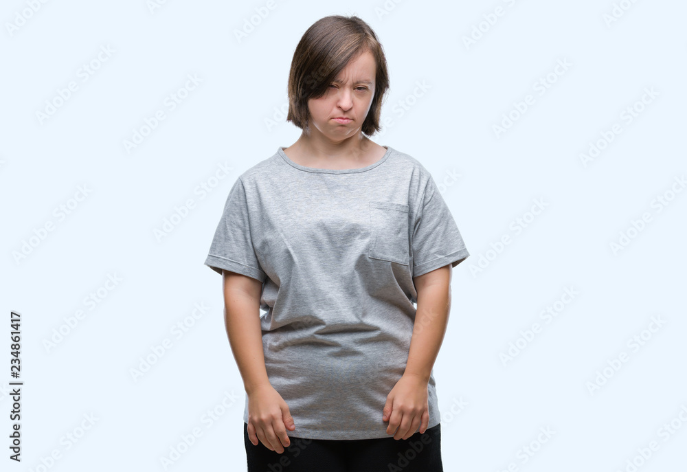 Young adult woman with down syndrome over isolated background depressed and worry for distress, crying angry and afraid. Sad expression. Young adult woman with down syndrome over isolated background depressed and worry for distress, crying angry and afraid. Sad expression.