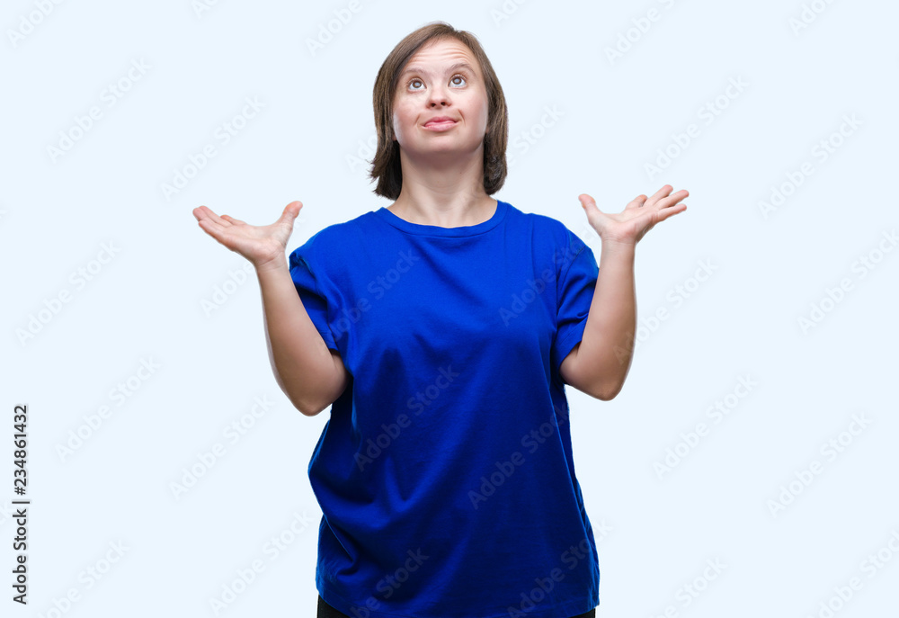 Young adult woman with down syndrome over isolated background celebrating crazy and amazed for success with arms raised and open eyes screaming excited. Winner concept Young adult woman with down syndrome over isolated background celebrating crazy and amazed for success with arms raised and open eyes screaming excited. Winner concept