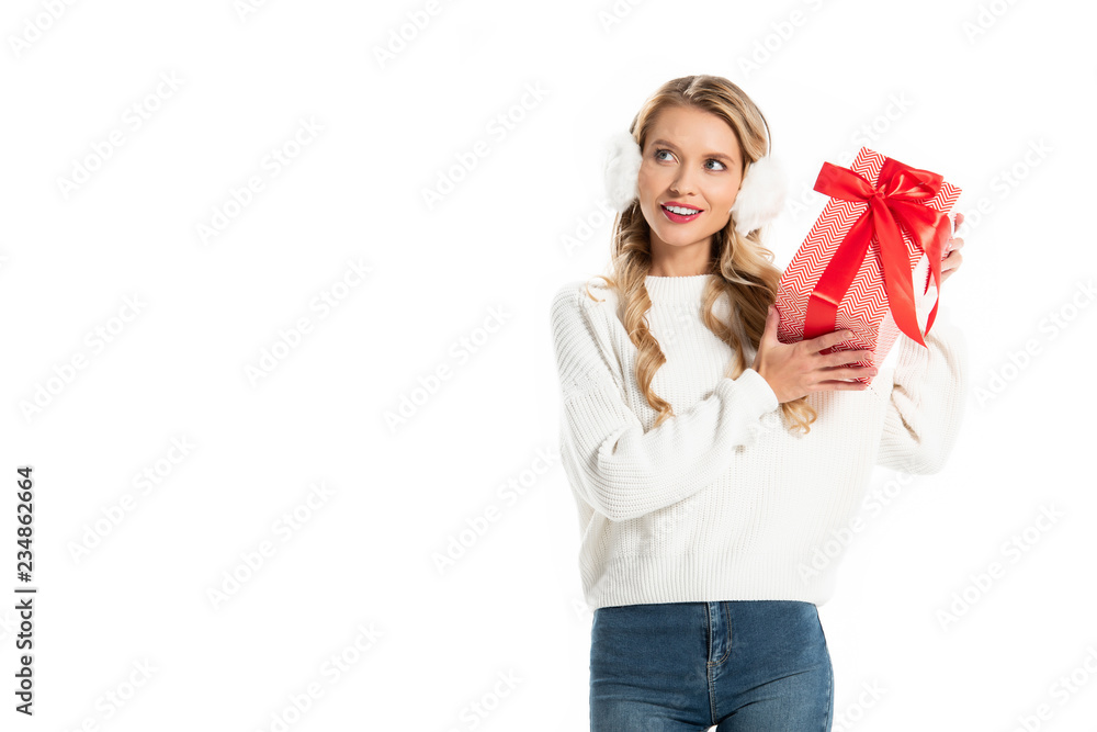 happy girl in winter outfit holding christmas gift box isolated on white happy girl in winter outfit holding christmas gift box isolated on white