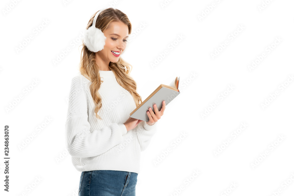 cheerful attractive woman in white earmuffs reading book isolated on white cheerful attractive woman in white earmuffs reading book isolated on white