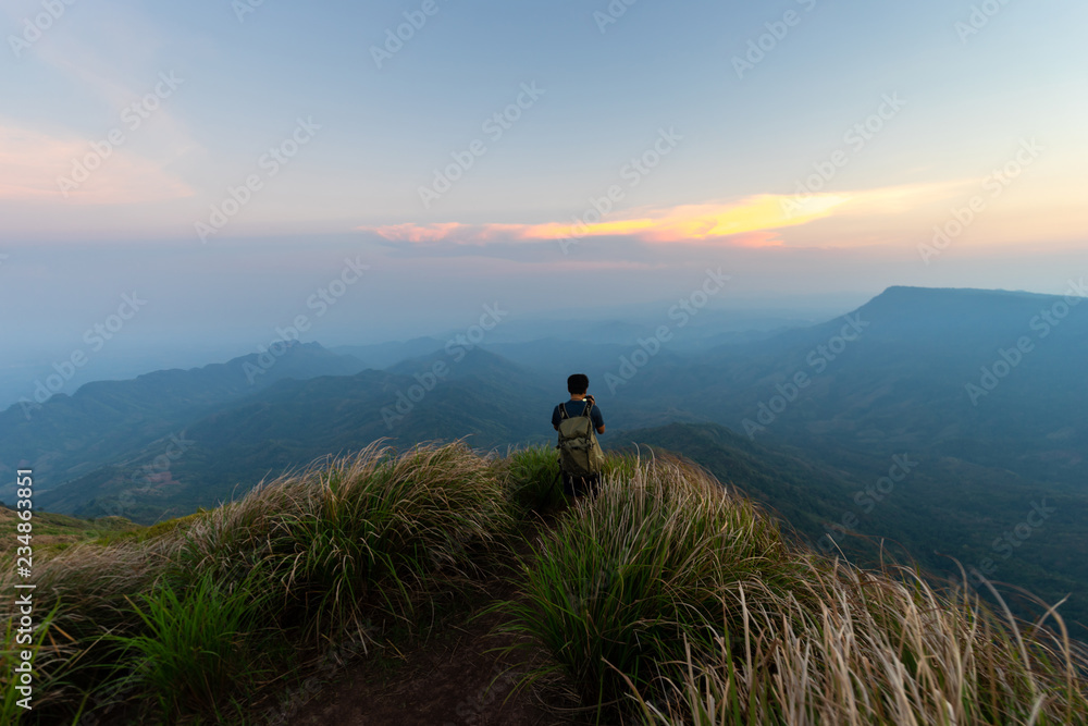 man traveller tourism photographer standing on top of a cliff mountain during sunset - landscape sunset Thailand man traveller tourism photographer standing on top of a cliff mountain during sunset - landscape sunset Thailand
