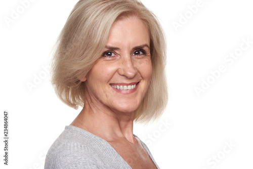 Cheerful pretty old lady is smiling. Skin and tooth care
