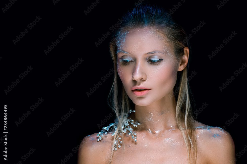 young woman with winter make up isolated on black
