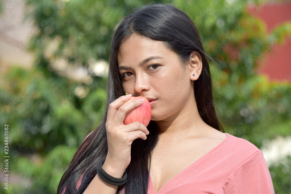 Serious Filipina Person With Fruit