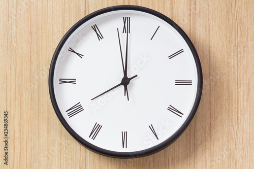 black and white clock on wooden wall in the morning, roman number clock