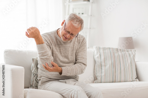 Canvas Print people, health care and problem concept - unhappy senior man suffering from elbo