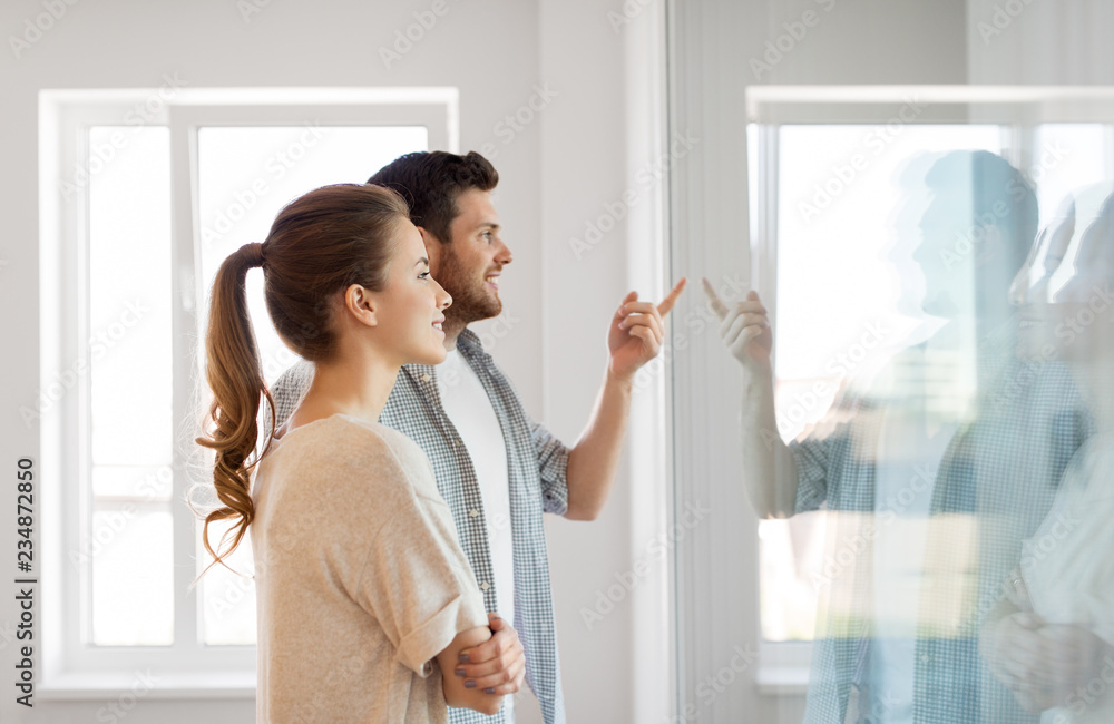 © Syda Productions - mortgage, people and real estate concept - happy couple looking through window at new home © Syda Productions - mortgage, people and real estate concept - happy couple looking through window at new home