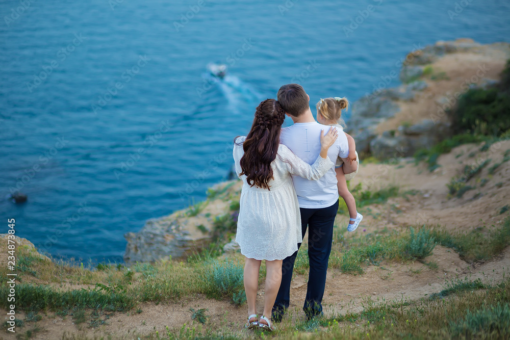 Couple family traveling together on cliff edge man and woman lifestyle concept summer vacations outdoor Crimean mountain top Couple family traveling together on cliff edge man and woman lifestyle concept summer vacations outdoor Crimean mountain top