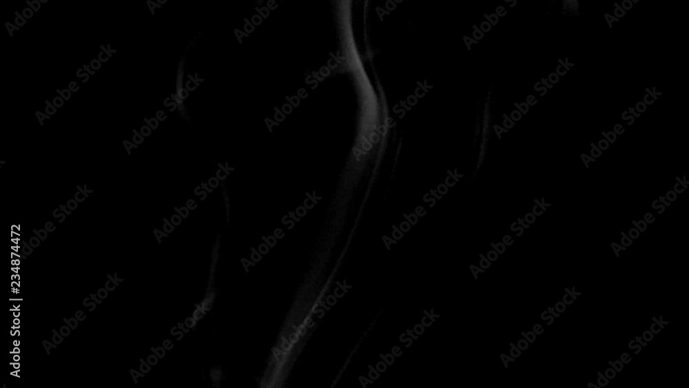 A slow motion smoke effect on a black background A slow motion smoke effect on a black background