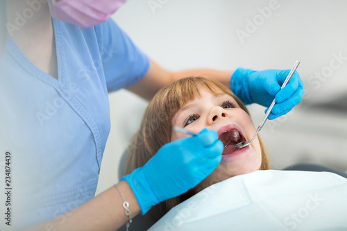 Fototapeta Naklejka Na Ścianę i Meble -  Female dentist and child in a dentist office