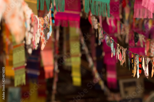 Soft focus of festival flags in door on poor lighting at temple in Thailand © taira42