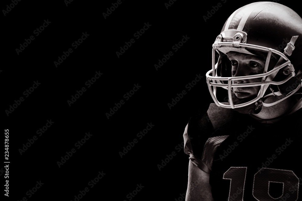 American football player standing with rugby helmet