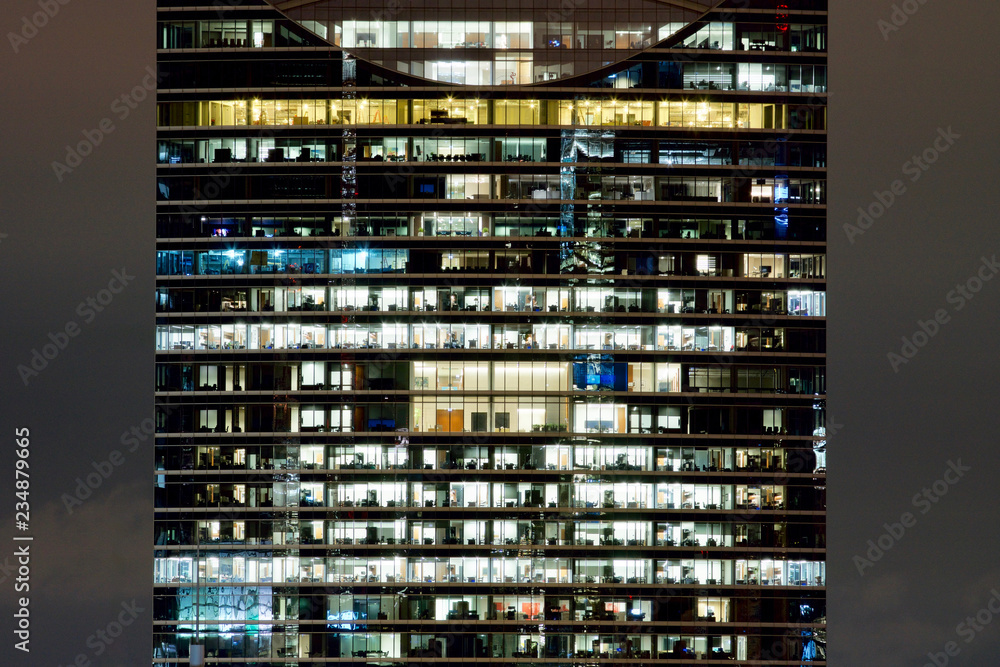 Symmetrical windows in an office building at night Symmetrical windows in an office building at night