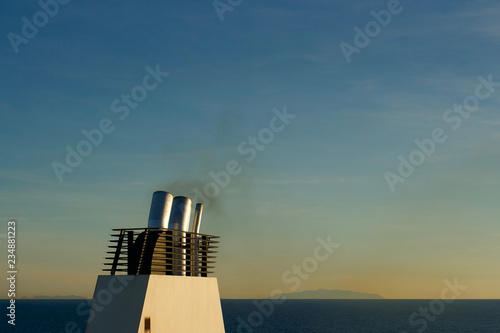 Ferry boat chimney on the sea at sunrise 