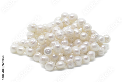 Natural cultered white pearl beads string on a white background isolated