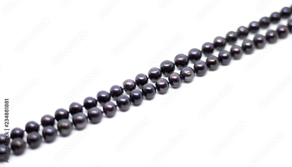 Natural cultered black pearl beads string on a white background isolated Natural cultered black pearl beads string on a white background isolated