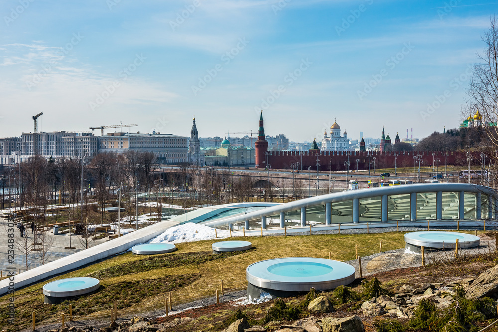 Zaryadye Park landscape in early spring sunny day with the Cathedral of Christ the Saviour and Moscow Kremlin on the horizon.