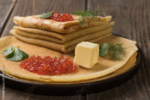 Closeup of pancakes with red caviar (russian blini)