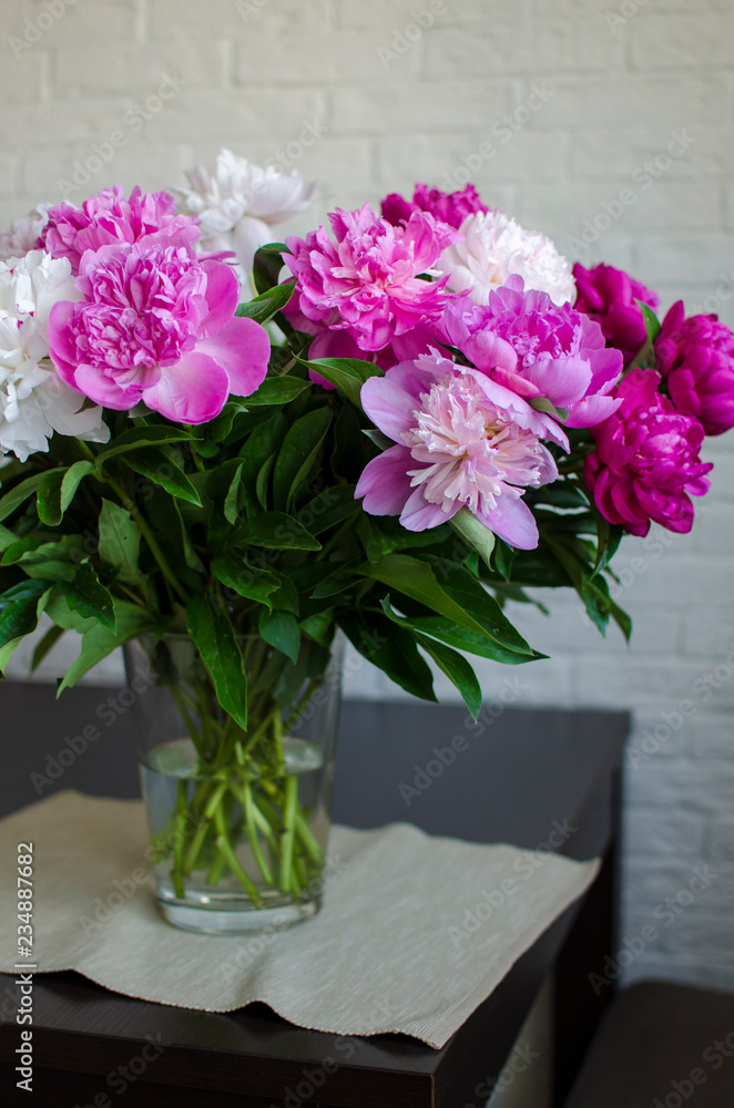 bouquet of flowers peonies in a vase on wooden table