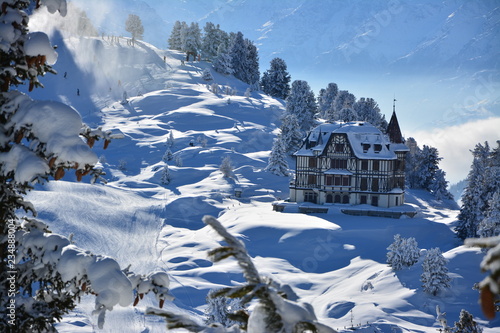 Winter landscape in the alps on bettmeralp with villa photo