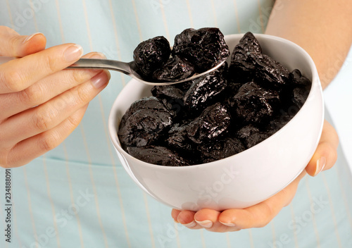 WOMAN EATING PRUNES photo