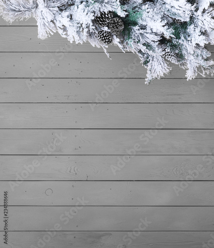 gray wooden christmas background with fir branches