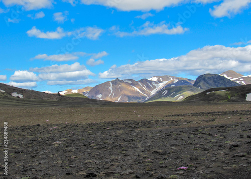 Landscape of Maelifellsandur volcanic black sand desert with Tindafjallajokull glacier and blue sky, summer in Highlands of Iceland photo