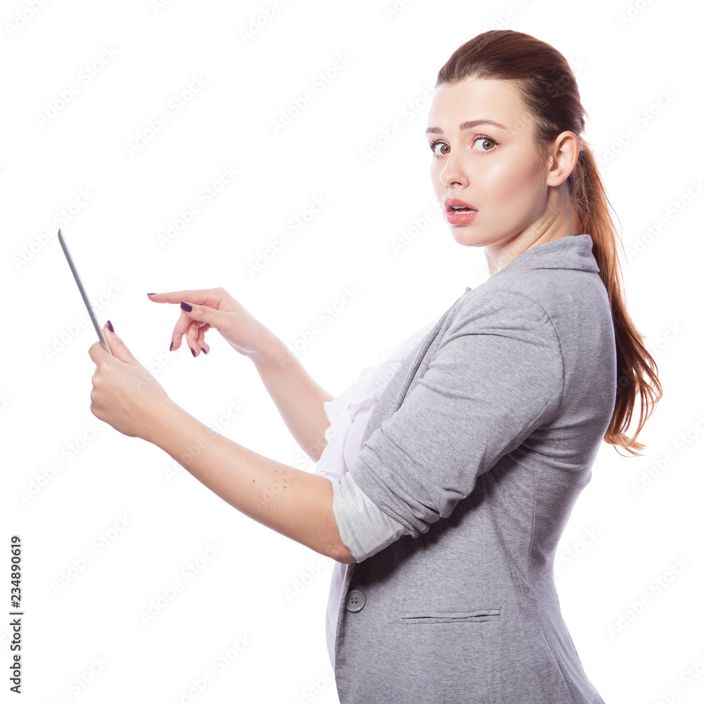 Brunette plus size woman in smart casual outfit (jacker and blouse) on an isolated white background. She holds gadgets in ger hands: tablet and phone. Freelance business concept: work in internet,SMM. Brunette plus size woman in smart casual outfit (jacker and blouse) on an isolated white background. She holds gadgets in ger hands: tablet and phone. Freelance business concept: work in internet,SMM.