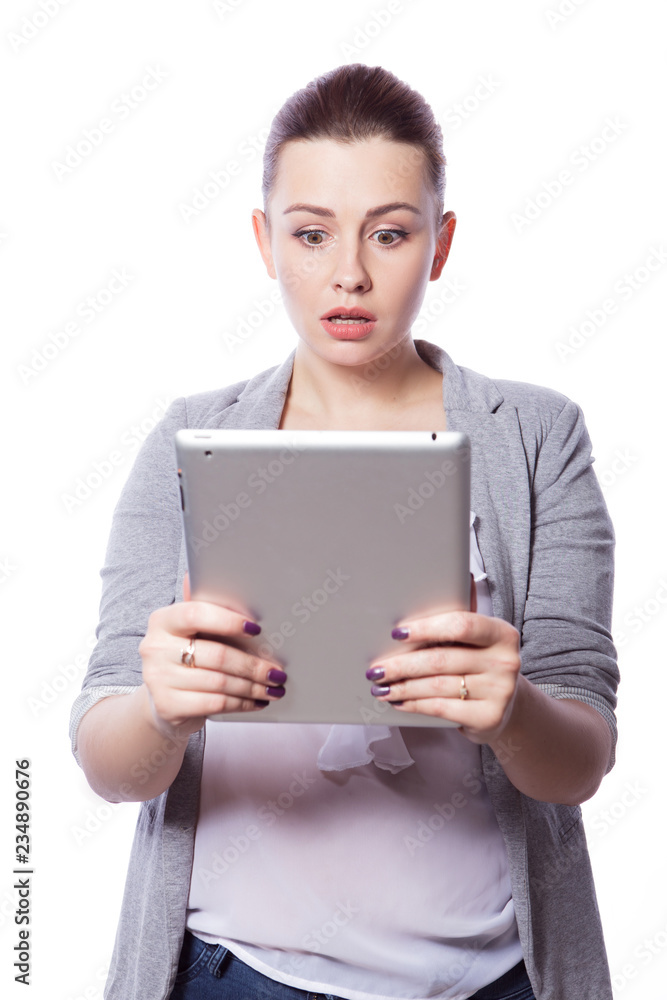 Brunette plus size woman in smart casual outfit (jacker and blouse) on an isolated white background. She holds gadgets in ger hands: tablet and phone. Freelance business concept: work in internet,SMM. Brunette plus size woman in smart casual outfit (jacker and blouse) on an isolated white background. She holds gadgets in ger hands: tablet and phone. Freelance business concept: work in internet,SMM.