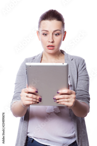 Wallpaper Mural Brunette plus size woman in smart casual outfit (jacker and blouse) on an isolated white background. She holds gadgets in ger hands: tablet and phone. Freelance business concept: work in internet,SMM. Torontodigital.ca