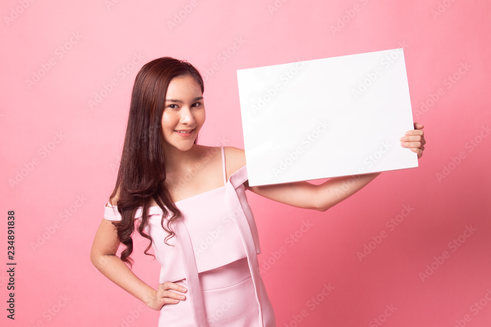 Young Asian woman point to blank sign. Young Asian woman point to blank sign.