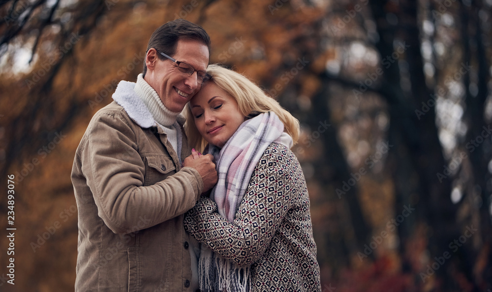 Senior couple in park in autumn Senior couple in park in autumn