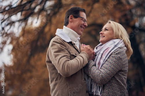 Senior couple in park in autumn