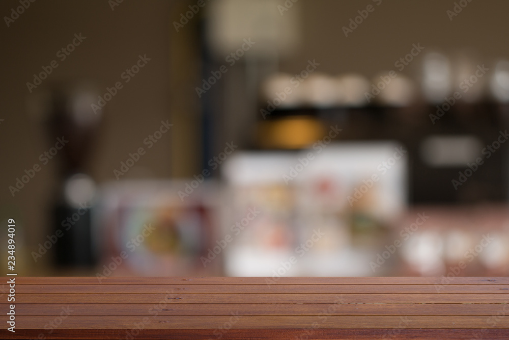 Wooden desk with Blurred of coffe's shop for abstract background