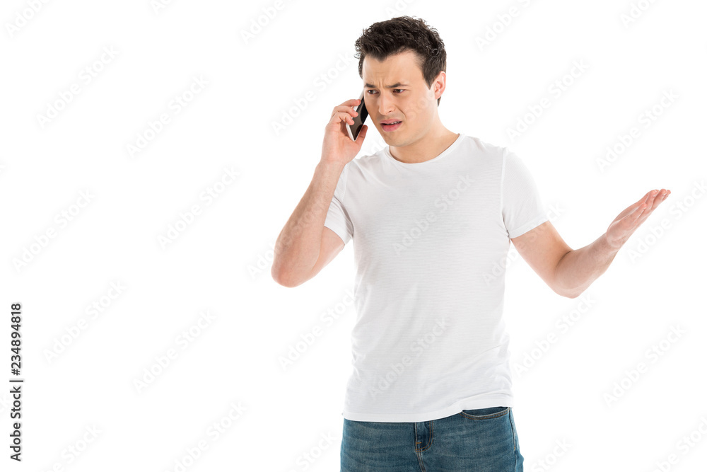 confused handsome man talking on smartphone isolated on white confused handsome man talking on smartphone isolated on white