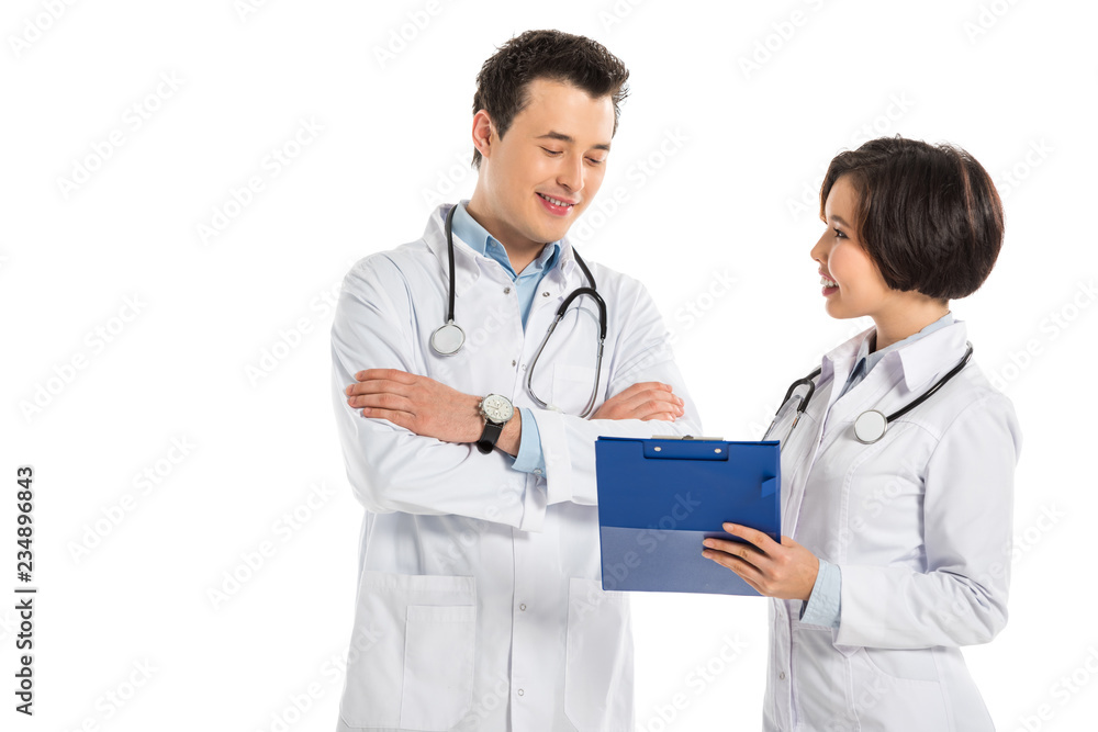 female doctor showing diagnosis to male doctor with crossed arms isolated on white female doctor showing diagnosis to male doctor with crossed arms isolated on white