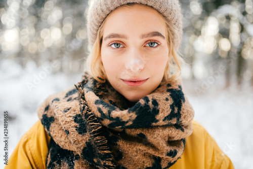 Adorable young beautiful girl lifestyle winter portrait. Pretty cute blue eyed female model outdoor. Sensual emotional face of amazing stylish woman. Cute hipster lady posing in fashionable clothes. photo