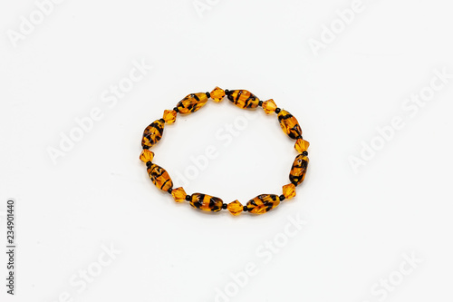 multiple colored and sized beads bracelet on white background
