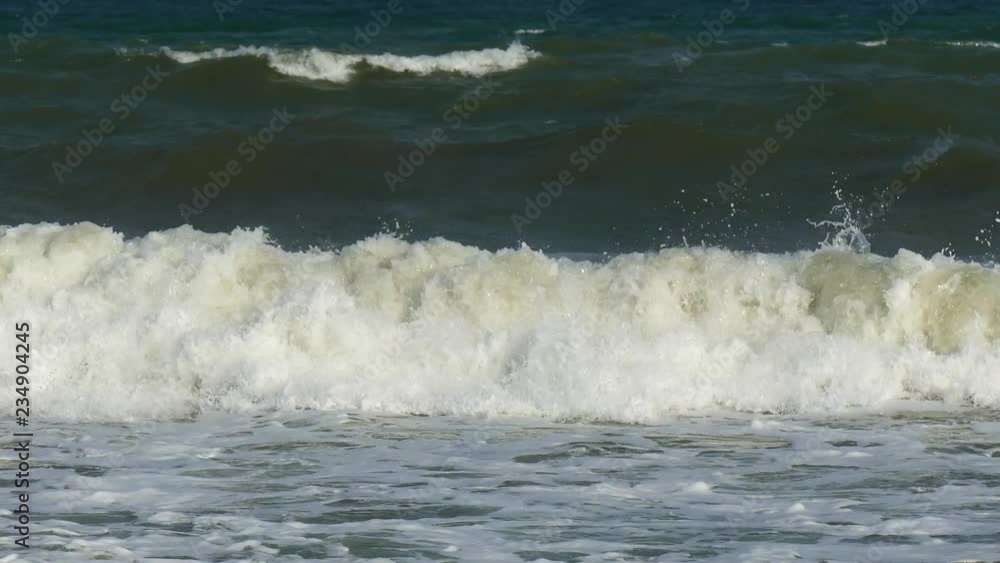 Waves of foam flood the seashore. Waves of foam flood the seashore.