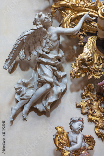 PRAGUE, CZECH REPUBLIC - OCTOBER 12, 2018: The carved polychrome baroque statue of angel from the side altar in St. Francis of Assisi church by M. V. Jäckel a J. K. Liška. (17. - 18. cent.).