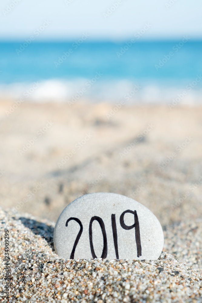 2019, as the new year, in a stone on the beach