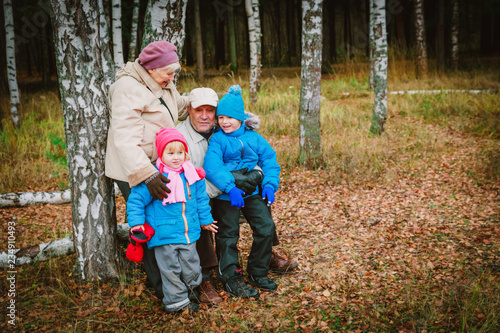 active senior grandparents with kids walk in nature © nadezhda1906