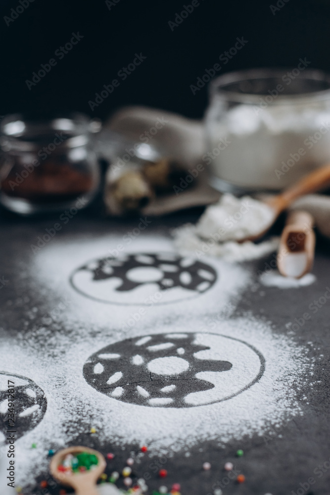 Ingredients for donuts baking. Spoon with flour, dishes, eggs, sugar on a grey background.Bakery background frame. Top view, copy space. Ingredients for donuts baking. Spoon with flour, dishes, eggs, sugar on a grey background.Bakery background frame. Top view, copy space.