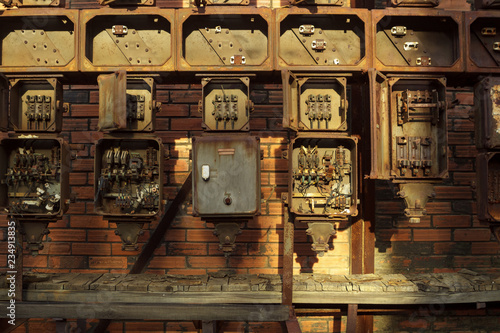 Rusty junction boxes in Lousal Iron sulphide mine Portugal photo