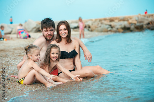 Happy family enjoying walk on the sea beach. The summer, childhood, holiday, leisure, lifestyle, travel, vacation concept