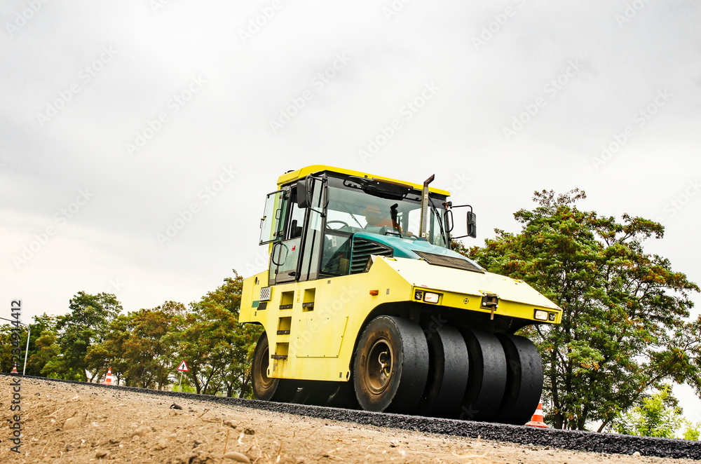 Close view on the road roller working on the new road construction site Close view on the road roller working on the new road construction site